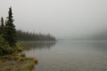 Morning fog over Cavell Lake in Canadian Rockies Royalty Free Stock Photo