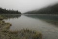 Morning fog over Cavell Lake in Canadian Rockies Royalty Free Stock Photo