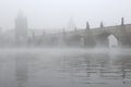 Morning fog over the Charles Bridge in Prague. Royalty Free Stock Photo