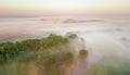Morning fog over river, meadow and forest. Amazing nature sunlight scene Royalty Free Stock Photo