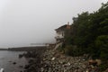 Morning fog over the shore with a house near the Black Sea Royalty Free Stock Photo