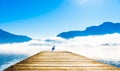 Morning fog on Pier of lake Mondsee and Alps in Austria