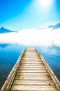 Morning fog on Pier of lake Mondsee and Alps in Austria Royalty Free Stock Photo