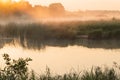 Morning fog on lake in the rays of the rising sun Royalty Free Stock Photo