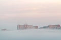 Morning fog under buildings in the city Zlin, Czech Republic.
