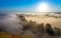 Morning foggy valley with river, hills and withered grass