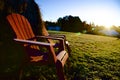 Morning frost in the Muskoka chairs sitting on a farm with lens flare