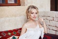 Morning girl resting sitting on a Turkish sofa. A woman in light clothes is preparing for the arrival of her beloved man Royalty Free Stock Photo