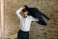 Morning of the groom. Groom morning preparation. Young and handsome groom getting dressed in a wedding shirt Royalty Free Stock Photo