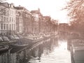 Morning haze at water canal, gracht, in Amsterdam, Netherlands.