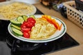 Morning healthy breakfast of scrambled eggs with parmesan cheese, cucumbers, cherry tomatoes and bell peppers in home Royalty Free Stock Photo