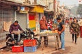 Morning of indian city with farm traders and man reading newspaper