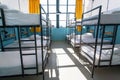 Morning inside the hostel bedroom with clean white beds for students and lonely young tourists Royalty Free Stock Photo