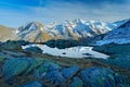 Morning in Italian Alps, mountains with small lake in the rock, hills in the clouds, Alp, Gran Paradiso, Italy. Royalty Free Stock Photo