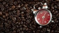 Morning joe, caffeine fix  and coffee time concept with a alarm clock on roasted coffee beans with copy space Royalty Free Stock Photo