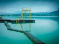 Morning at the lake in Walchsee with jetty and diving tower