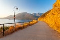 Morning landscape with lamps near the road, mountains and sea.