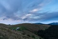 Morning landscape in the mountains. Dawn in the mountains. Rural huts on top of the mountain. Cloudy sky over the village Royalty Free Stock Photo