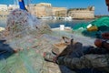 Morning landscape photo made in Gallipoli pier, fishermen reparing his fishermen net after fishing, Apulia, Italy