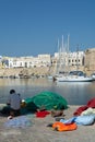 Morning landscape photo made in Gallipoli pier, fishermen reparing his fishermen net after fishing, Apulia, Italy