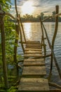 Abandoned hand made wooden pier by the river