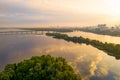 Morning Landscape with River Surface, an island with trees, a bridge and a city on the horizon Royalty Free Stock Photo