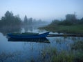 small river, morning fog over water, boat