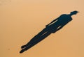 Human shadow cast gently across sandy ground.AI Generated Royalty Free Stock Photo