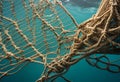 Heavy fishing net submerged in clear blue ocean water. AI Generated Royalty Free Stock Photo