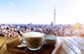 Morning light with hot cappuccino coffee on a wooden table over the panorama view Royalty Free Stock Photo