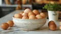 Morning light illuminates raw eggs in a ceramic bowl on a kitchen counter Royalty Free Stock Photo