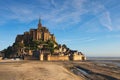 Morning light on Mont Saint Michel abbey. Landscape photo of famous Abbey during sunrise. Normandy, France Royalty Free Stock Photo