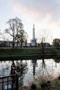 Riga, Latvia, November 2019. Reflection of trees and architecture in the calm water of a canal.