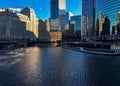 Morning light reflects over winter ice on Chicago River in February.