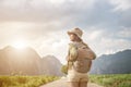 Morning light and young woman travel backpacking on road and forest background Relax time on holiday concept travel
