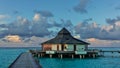 Morning in the Maldives. Above the aquamarine ocean there is a wooden walkway Royalty Free Stock Photo