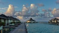 Morning in the Maldives. Two rows of water villas stretch over the aquamarine ocean. Royalty Free Stock Photo
