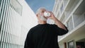 Morning man drinking coffee at downtown closeup. Senior male reading newspaper Royalty Free Stock Photo