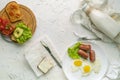 morning meal concept, table with milk with eggs and nutritious sandwichs Royalty Free Stock Photo