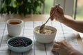 Woman eating healthy breakfast with oatmeal porridge with summer berries. Dieting, weight loss. Royalty Free Stock Photo