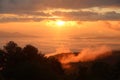 Morning mist covered on hill after sunrise at tropical forest. Royalty Free Stock Photo