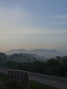 Morning mist covering the mountains near the highway