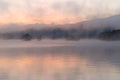 Morning mist drifting over a lake at sunrise Royalty Free Stock Photo