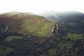 Morning mist house in the mountain peaks on natural landscape. Green valley on background foggy dramatic sky, mountain tops Royalty Free Stock Photo