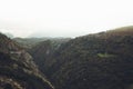 Morning mist house in the mountain peaks on natural landscape. Green valley on background foggy dramatic sky, mountain tops Royalty Free Stock Photo