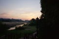 Morning mist over the river. Taken at dawn. In the foreground is a wooden staircase leading to the river. On the horizon are multi Royalty Free Stock Photo