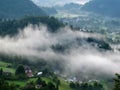 Morning mist walks above the village near Bled lake, Slovenia Royalty Free Stock Photo