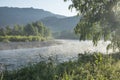 Morning on a mountain river, forested shores, light fog. Travel and vacation