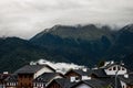 Morning in the mountains after the rain. White clouds.black roof