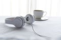 Morning music background. Coffee in white bed, sheet, duvet and pillow, messed up. Royalty Free Stock Photo